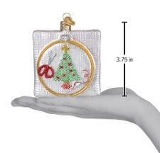 3.75 inch Christmas cross stitch ornament featuring a tree and scissors in an embroidery hoop.