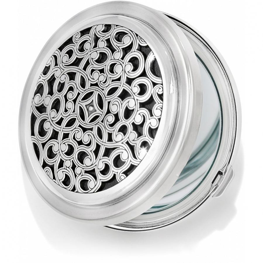 Silver-plated Serendipity Compact Mirror with an intricate sculpted scrollwork design on the lid.