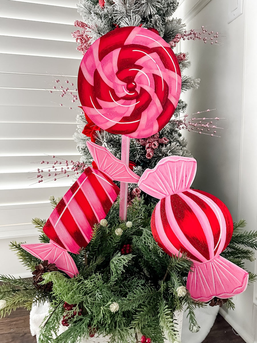Pinkmas Lollipop stake with a pink lollipop-shaped top on a wooden stick.