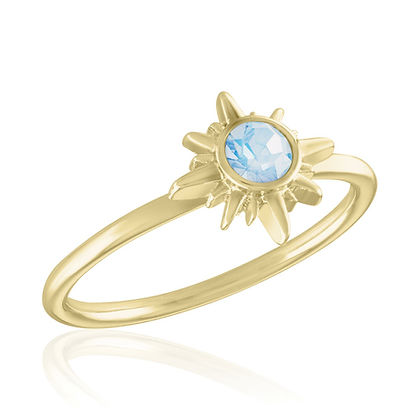 Gold Layers Ring featuring a sunburst design set with a round light blue gemstone.