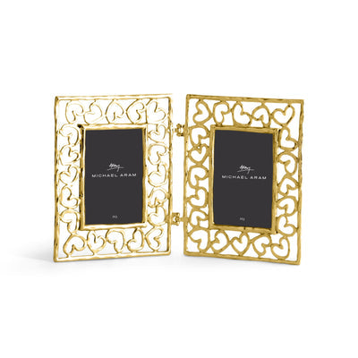 Gold hinged heart-shaped picture frame with a rectangular opening holding a photo.