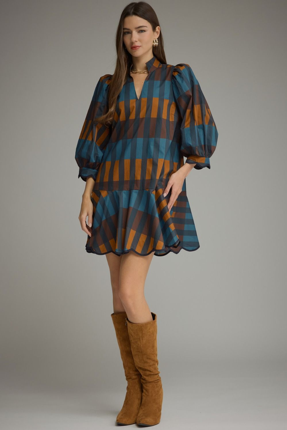 Woman wearing the Harper Plaid 3/4 Balloon Sleeve Mini Dress with brown suede boots.