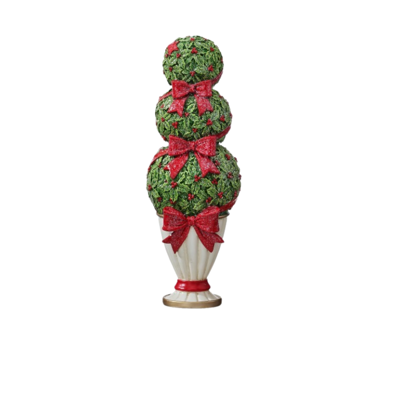 Resin holiday topiary with three holly leaf spheres, red bows, and berries in a white fluted pot.