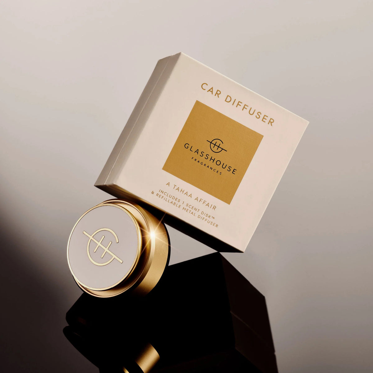 Glasshouse Fragrances A Tahaa Affair Car Diffuser with gold metal diffuser and packaging box.