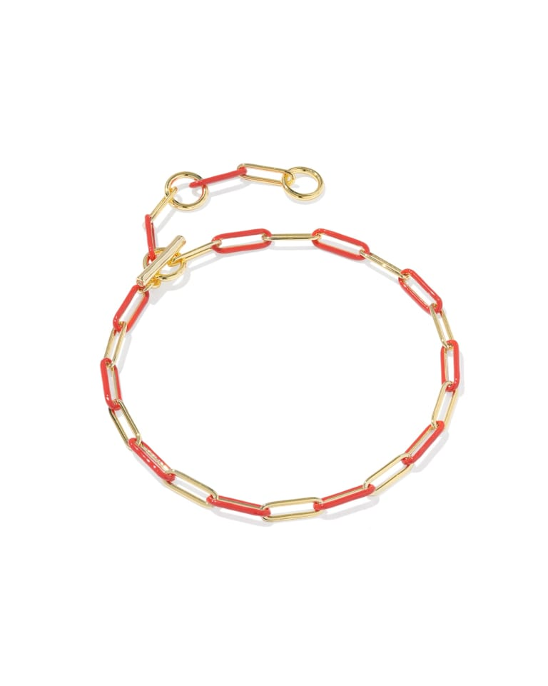 Courtney gold chain bracelet with alternating red enamel links and a toggle closure.