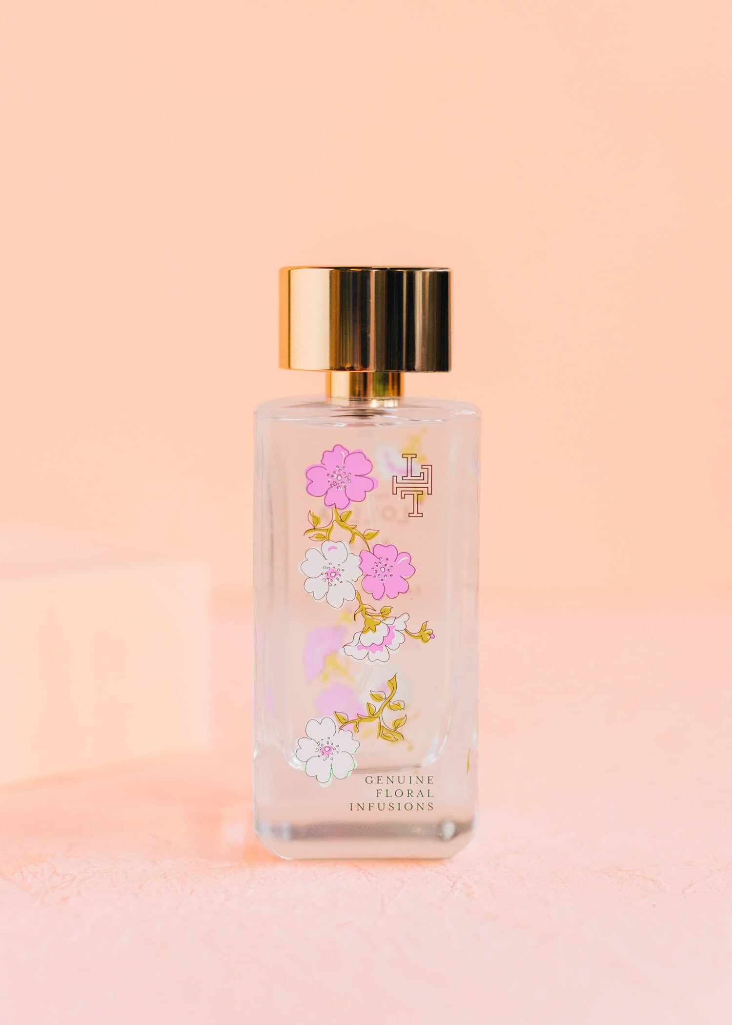 Relax Eau De Parfum bottle with delicate blossom field label on clear glass