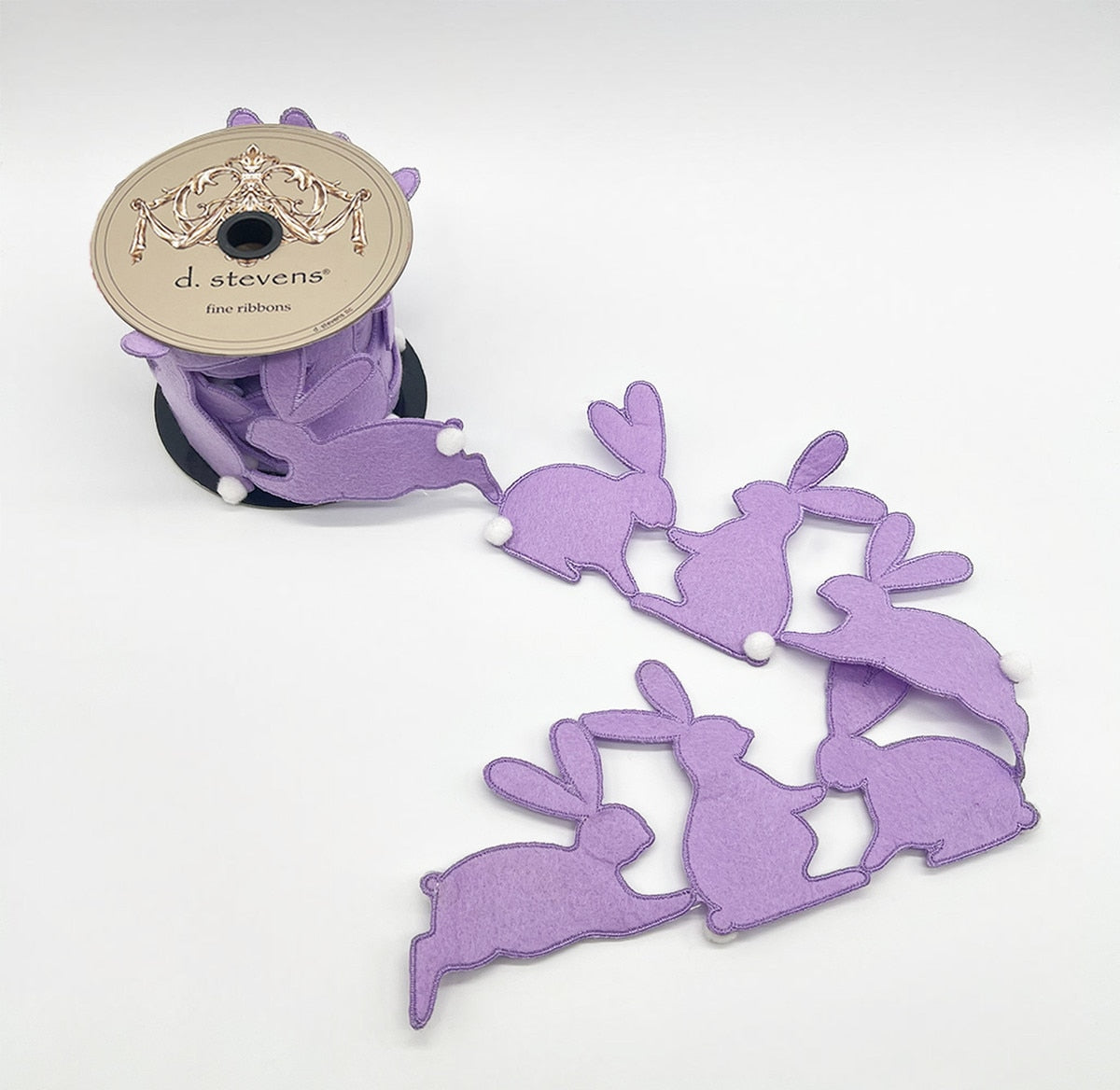 Lavender ribbon garland with rabbit silhouettes strung along a soft fabric strip.