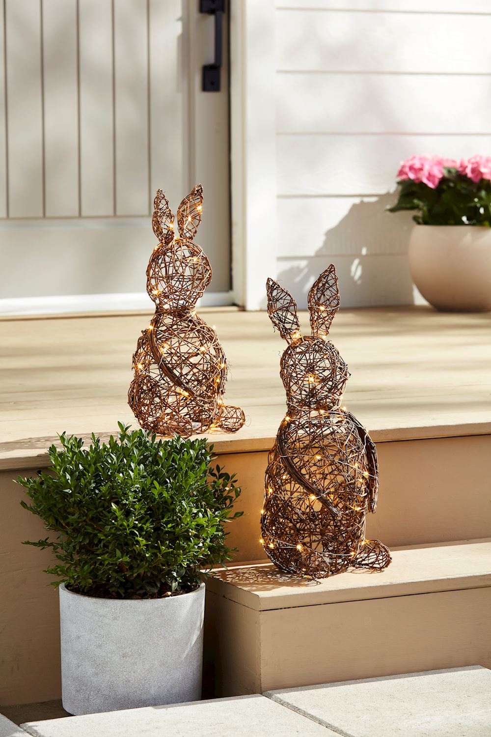 Rattan LED bunny sitter with glowing eyes in a seated pose