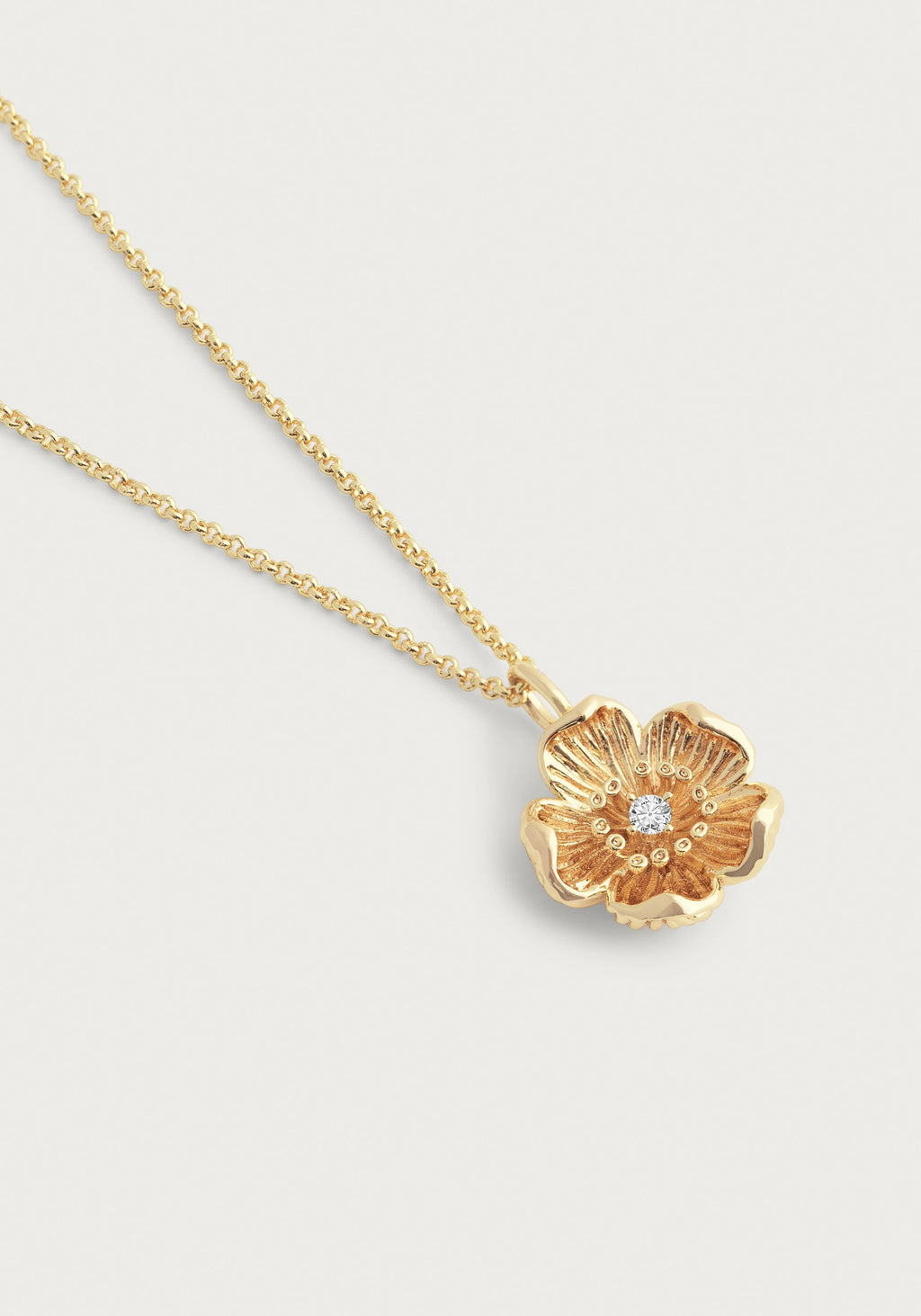 Wildflowers Gold Pendant Necklace featuring a gold-plated flower with a central crystal.