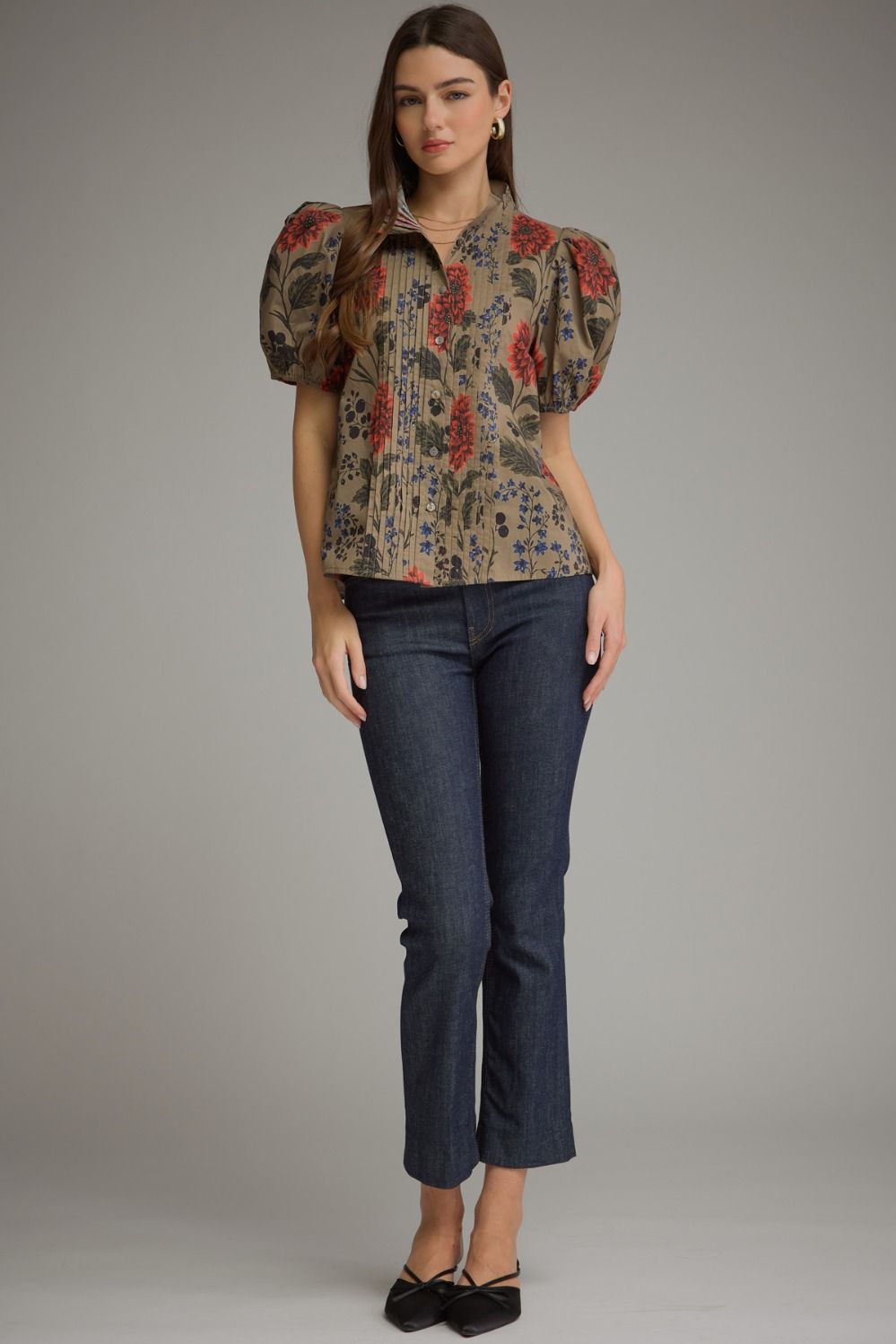 Woman wearing the Amanda Floral Short Puff Sleeve Top in olive with dark wash jeans.