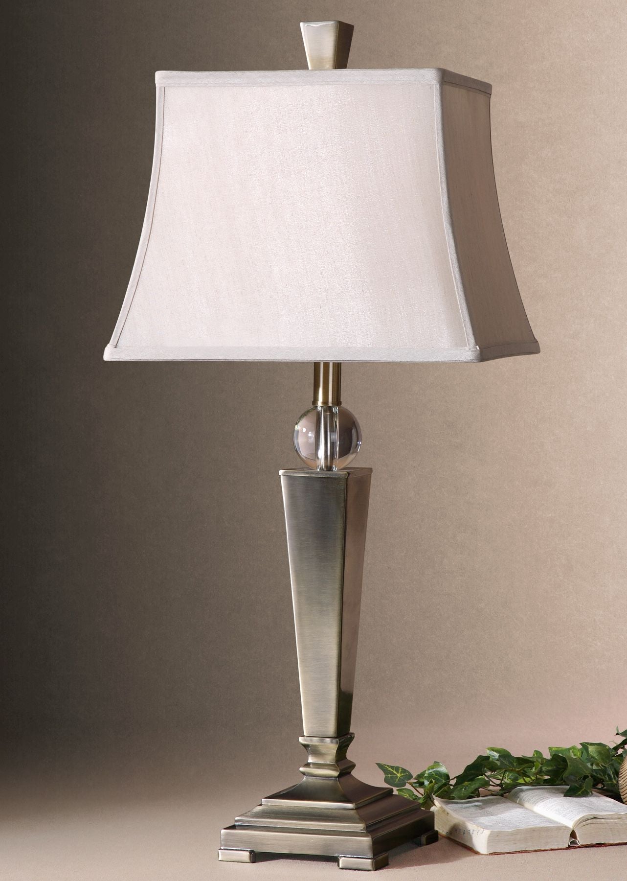 Mantello table lamp with a square white shade, crystal accent, and brushed metal base.