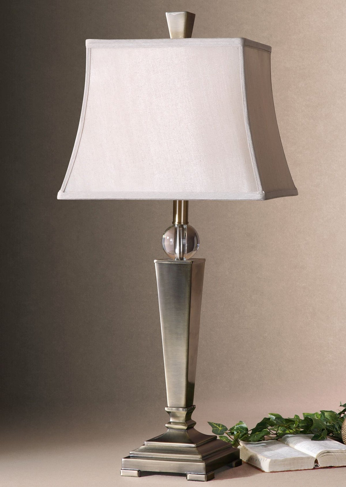 Mantello table lamp with a square white shade, crystal accent, and brushed metal base.