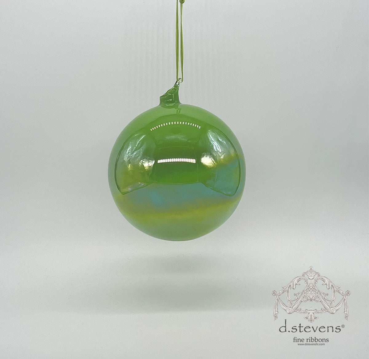 150mm lime green hand-blown glass ornament with a luminous iridescent finish and hanging loop.