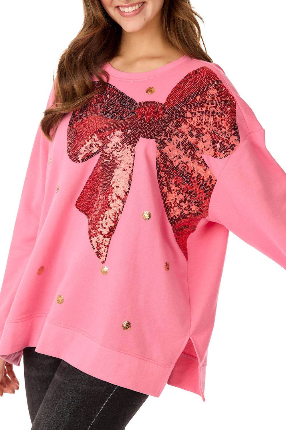 Pink oversized sweatshirt featuring a large red sequin bow and gold sequin polka dots.