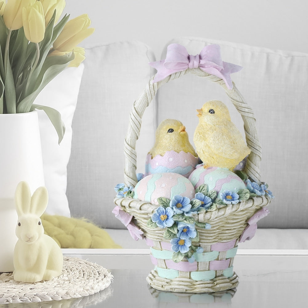 Resin Easter basket figurine with two yellow hatching chicks, pastel eggs, and blue flowers.