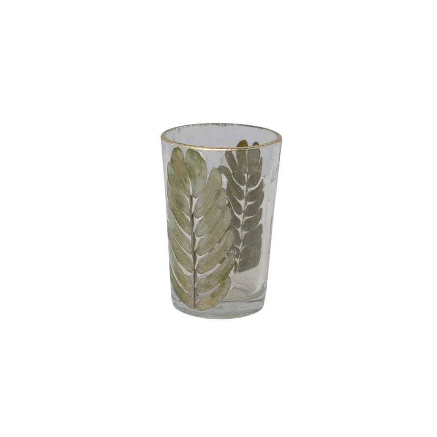 Hand-blown glass votive holder with embedded tamarind leaves and gold foil edge.