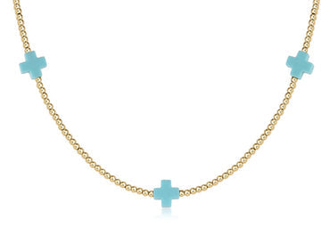A 15-inch choker necklace featuring a signature cross pendant made from gold-filled beads.