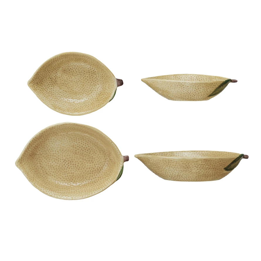 Stoneware lemon-shaped bowl in pale yellow with a textured rind pattern.