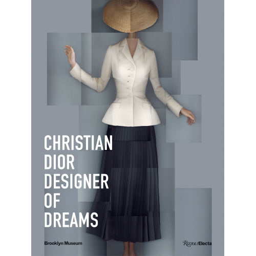 Christian Dior Designer of Dreams book cover featuring a white jacket and dark pleated skirt.