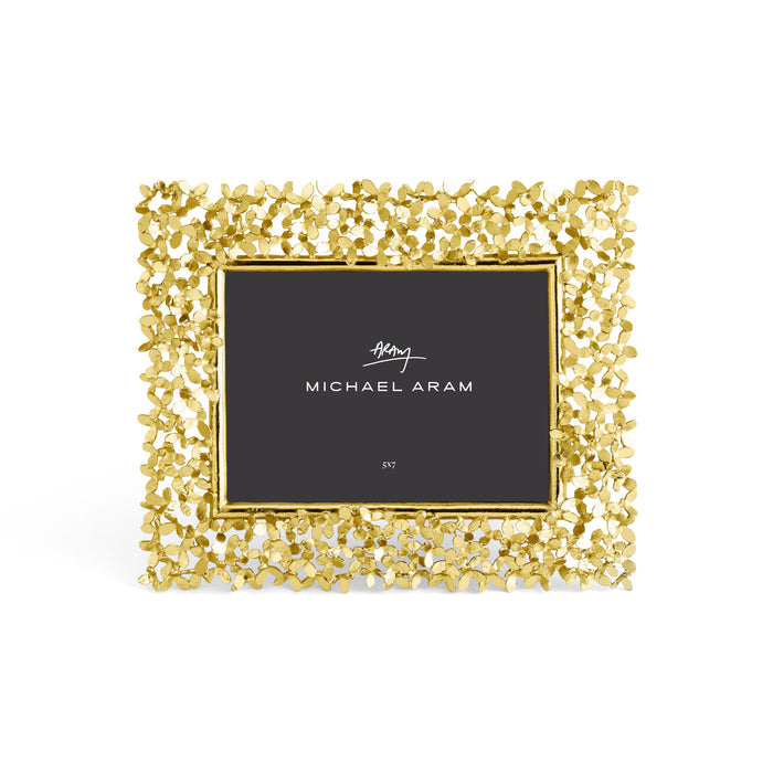 Goldtone rectangular picture frame with a dandelion motif holding a 5x7 photo.