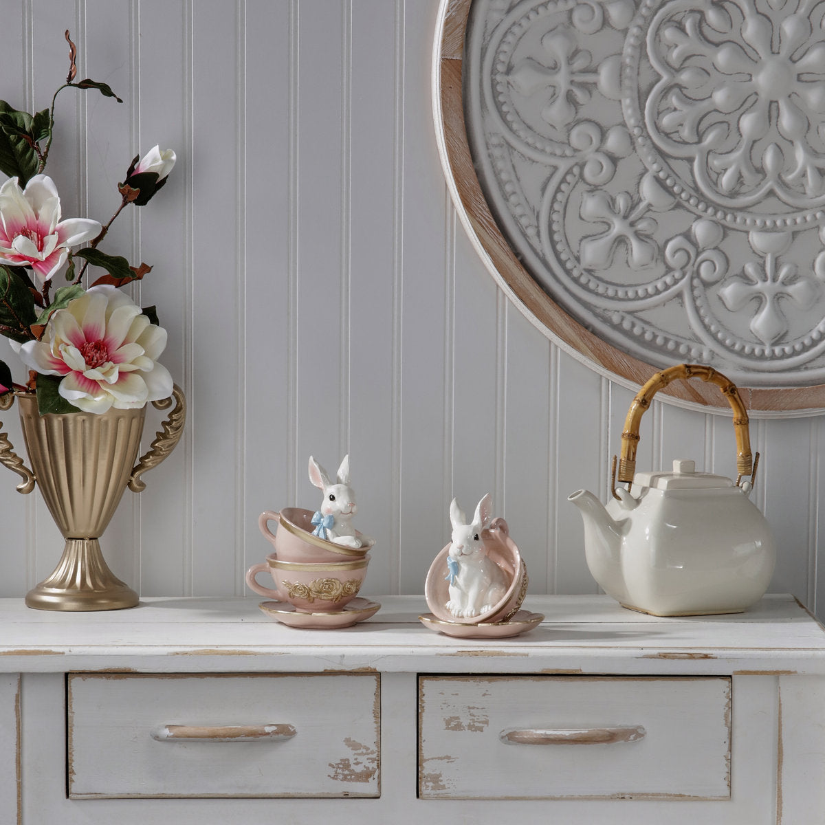 Hand-painted white resin bunny teacup with floral accents on a stand