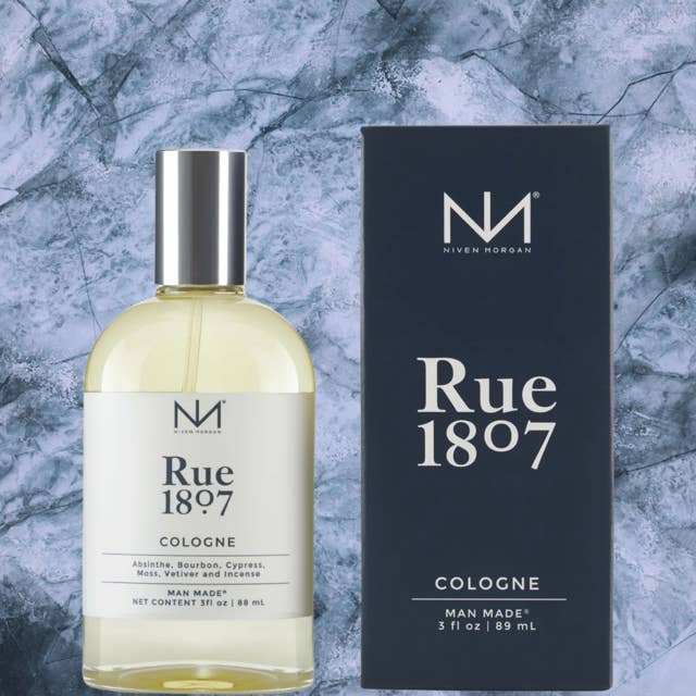 Bottle of Rue 1807 Cologne with dark amber liquid