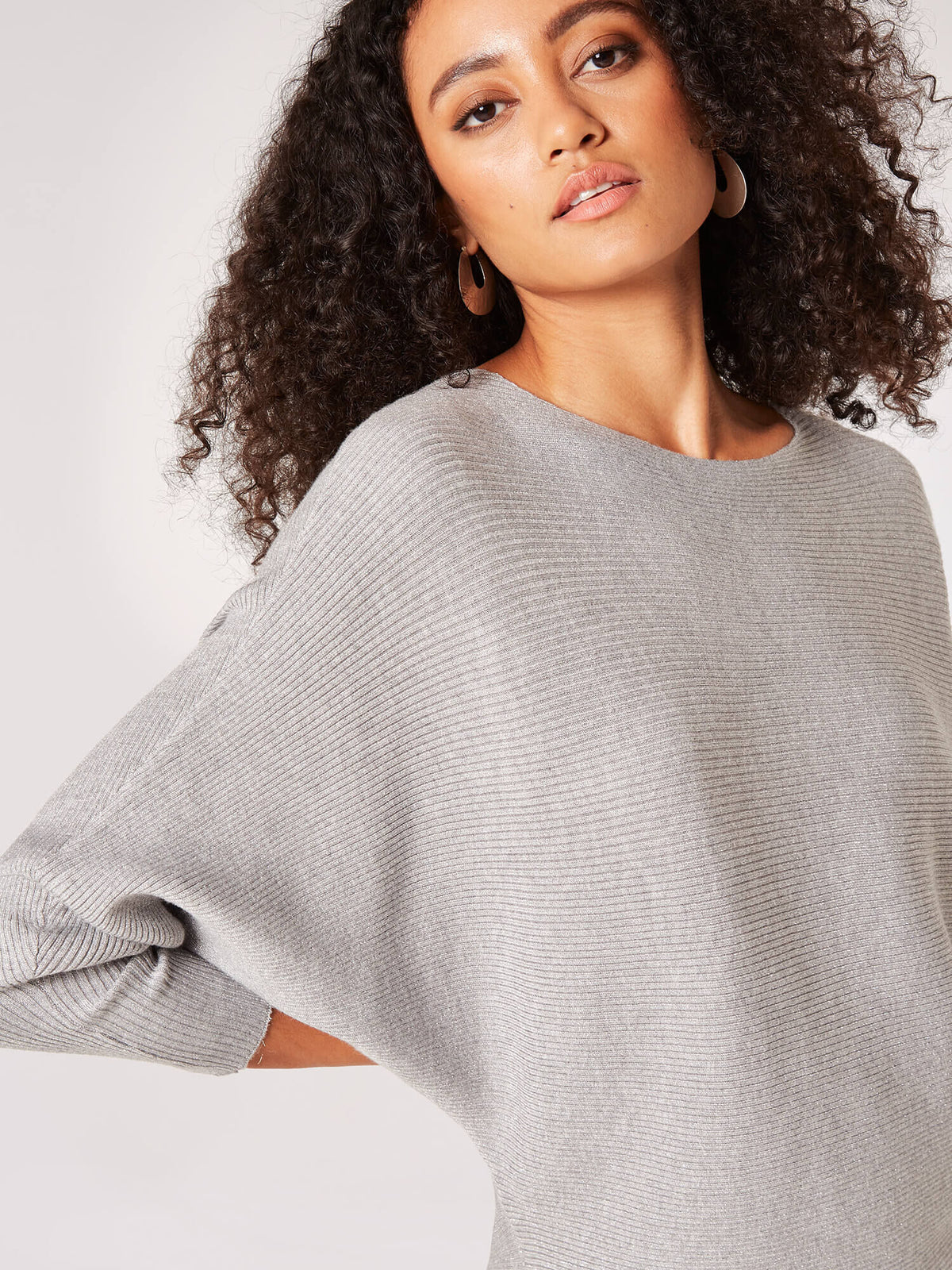 Evelyn Lurex ribbed batwing top in black with a relaxed silhouette and long sleeves.