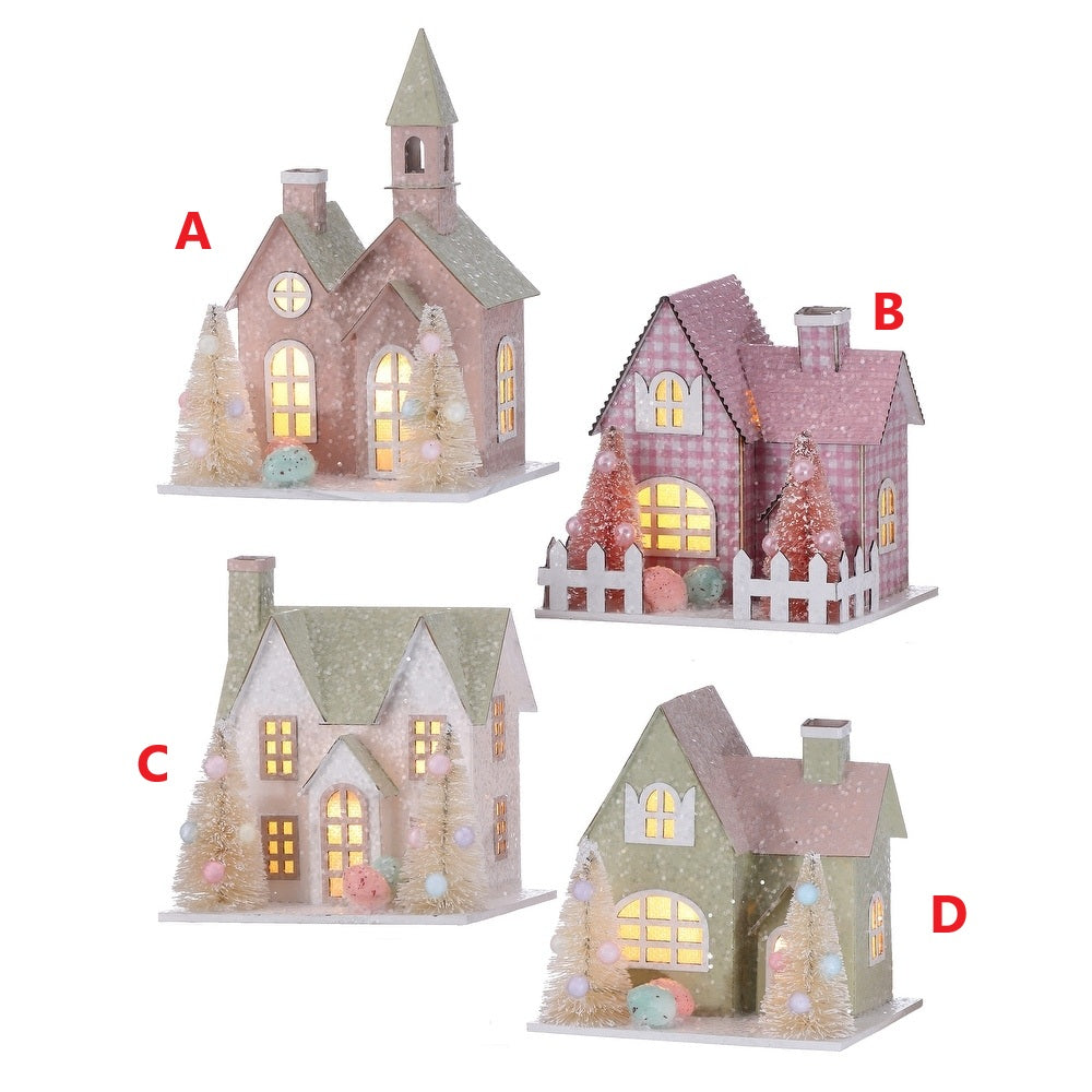 Cardboard Easter house with soft LED lights, sugared finish, and decorative trees in warm tones.