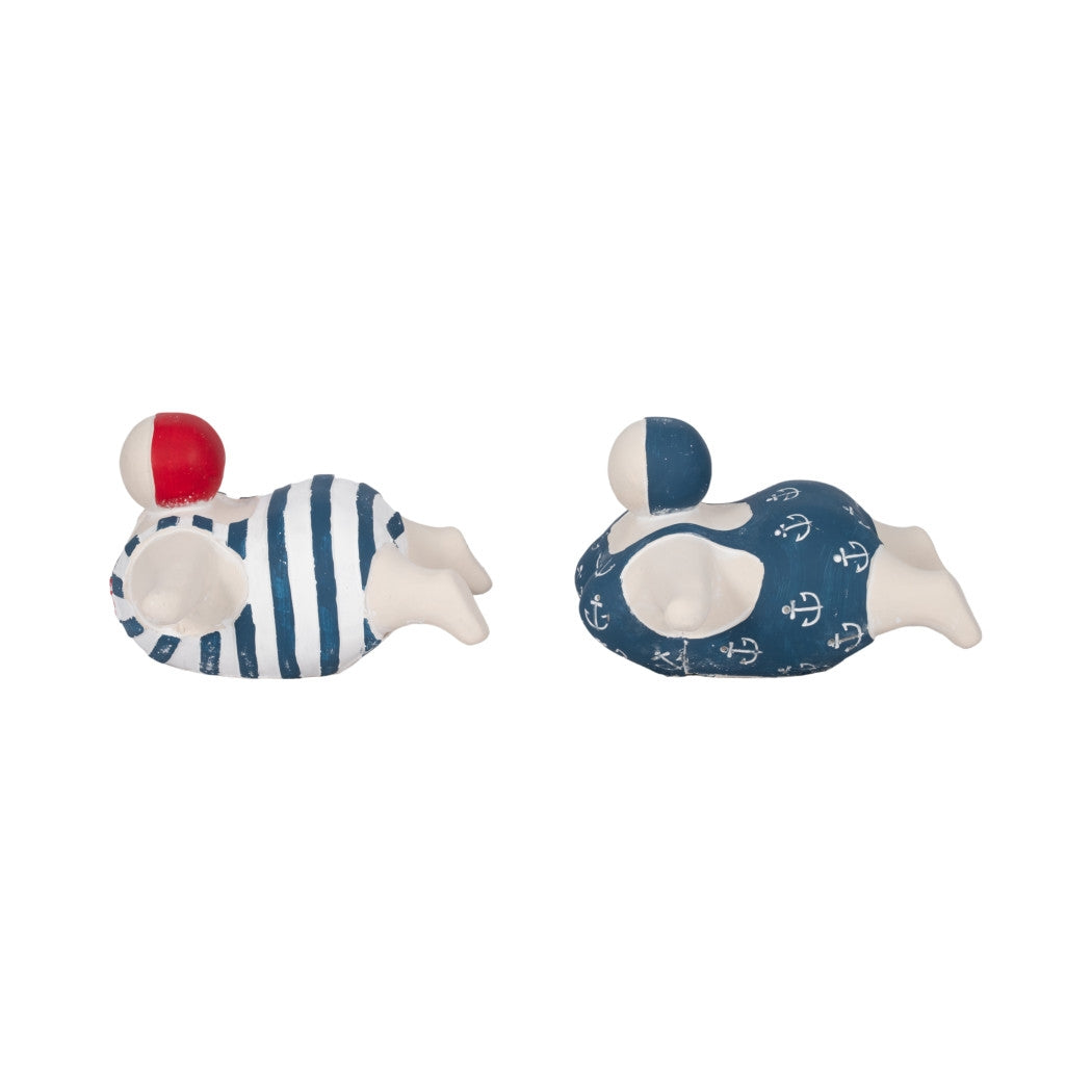Two ceramic bathing beauty figurines in blue and white swimwear, one striped and one with anchors.