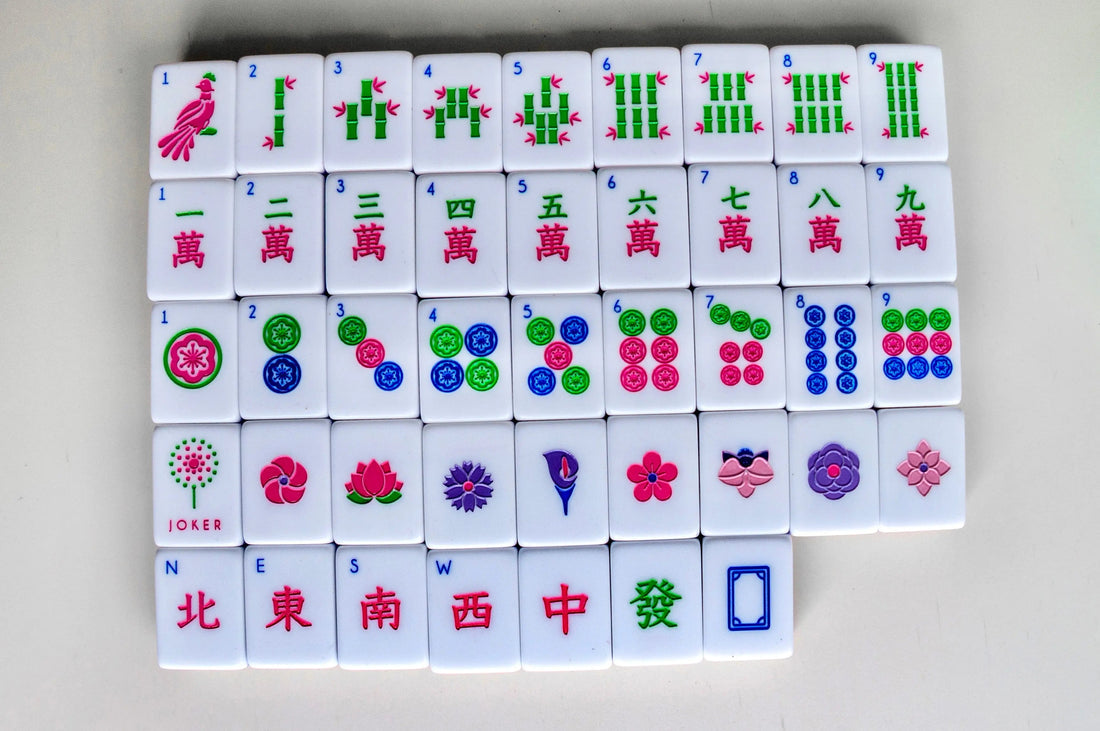 Set of acrylic spring mahjong tiles in red, green, white dragons with floral and dot patterns.