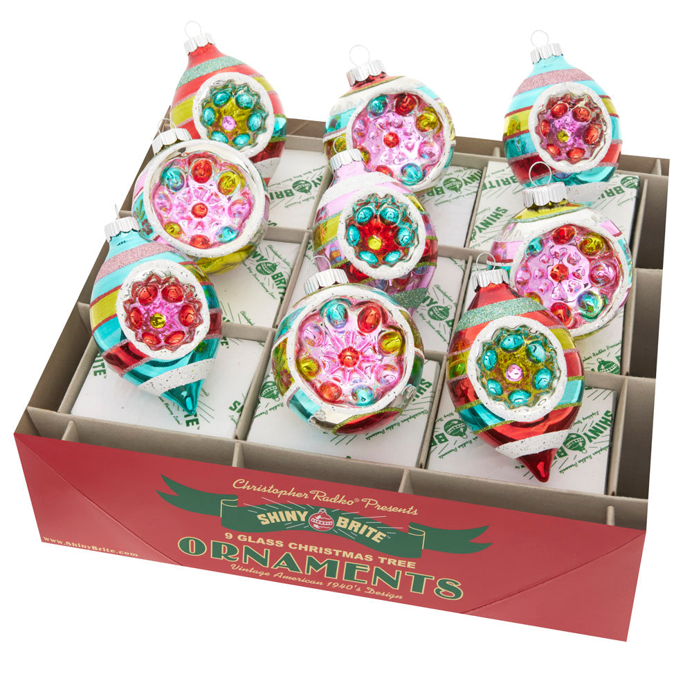 Set of 9 Shiny Brite glass Christmas ornaments with colorful stripes and reflector tulip centers.