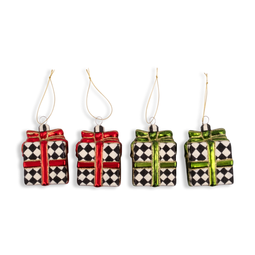 Four glass gift box ornaments with black and white checkered patterns and red or green ribbons.
