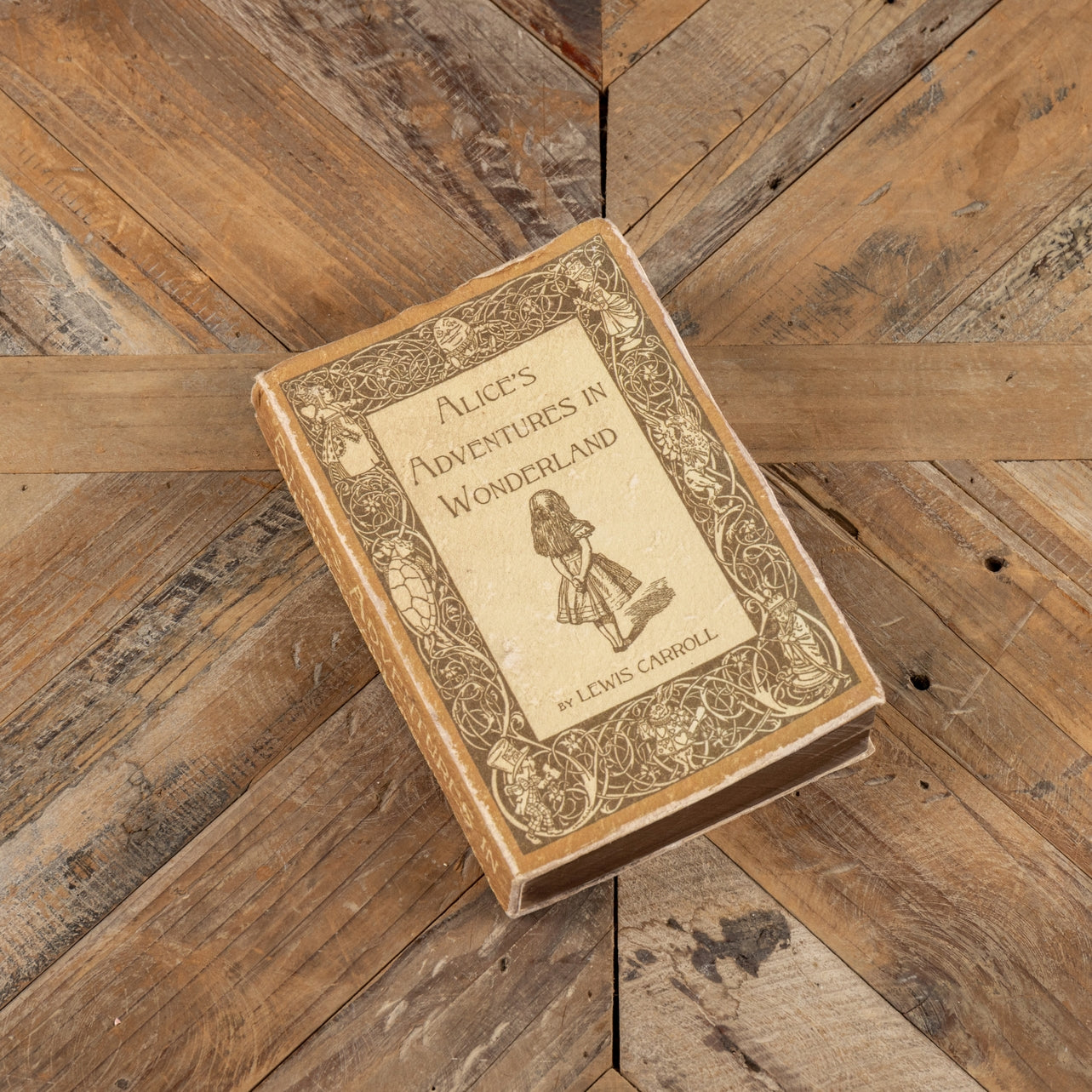 Alice's Adventures in Wonderland journal with a whimsical illustration cover pattern.