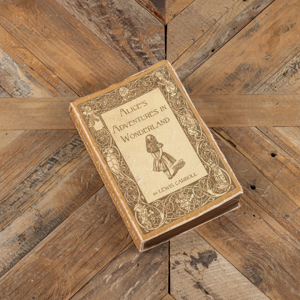 Alice's Adventures in Wonderland journal with a whimsical illustration cover pattern.