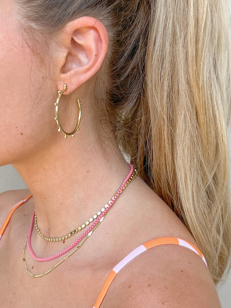 Medium Sweetie Pie Hug Hoops in black with a heart-shaped cutout silhouette.