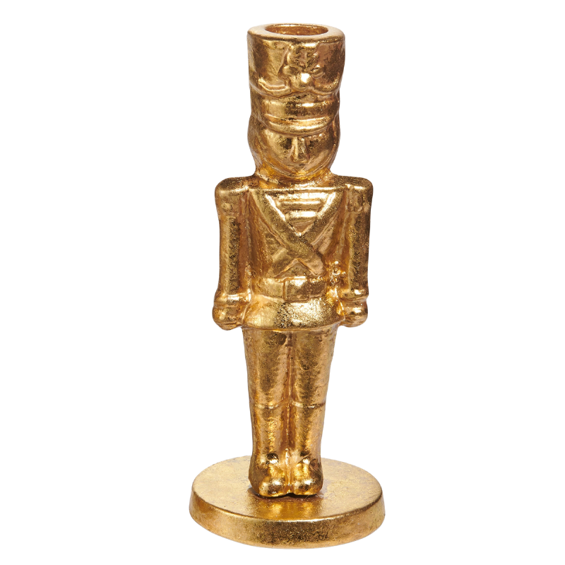 Gold iron nutcracker candlestick holder standing on a circular base.