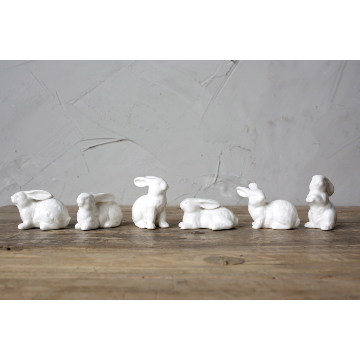 Small white ceramic bunny figurine with smooth rounded ears measuring approximately one inch wide.