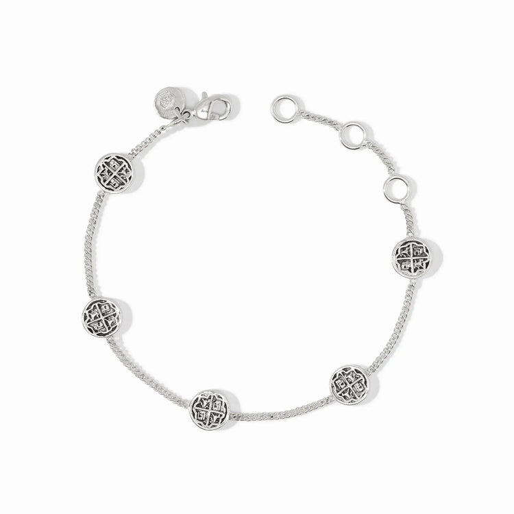 Delicate silver chain bracelet with five small coin stations on an adjustable length.