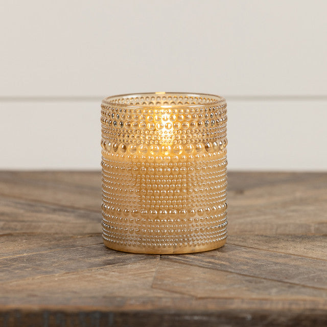 4-inch champagne glass candle with dotted texture featuring a realistic flame shape.