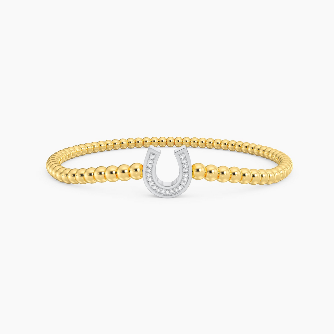 Lucky Horseshoe Beaded Bracelet featuring gold beads and a diamond-encrusted silver horseshoe charm.