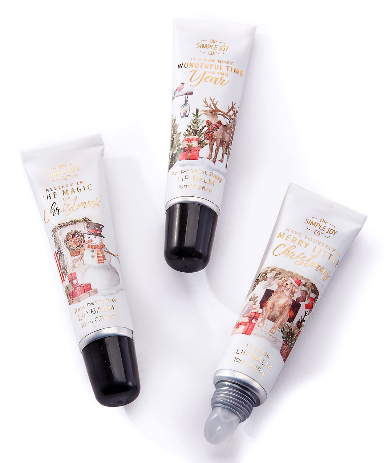 Three Christmas-themed lip balm tubes: Raspberry Ice, Peppermint Patty, and Fireside.