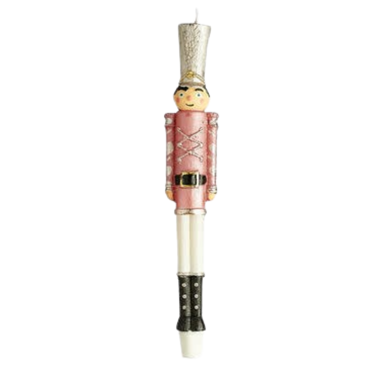 Pink and white soldier nutcracker taper candle with silver hat and black boots.