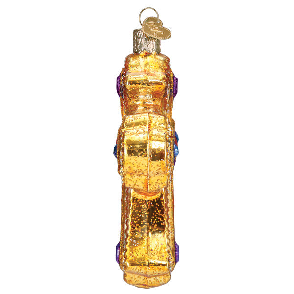 Side view of a gold glittered Ornate Cross Ornament with purple and blue jewel accents.