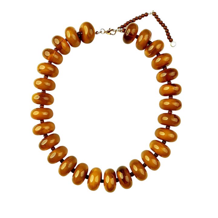 Bailey Chunky Beaded Necklace featuring large, glossy marbled amber-colored beads.