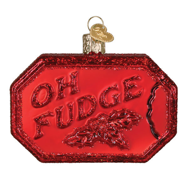 Red glittery glass soap bar ornament with embossed text reading OH FUDGE and holly leaf design.