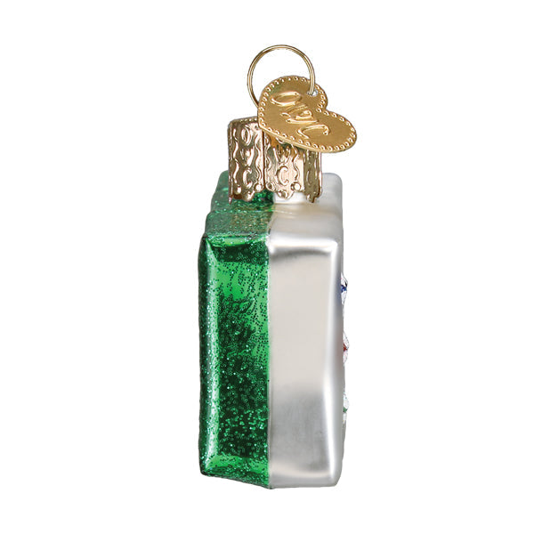 Side view of a Mahjong tile Christmas ornament with a green glitter back and silver front.