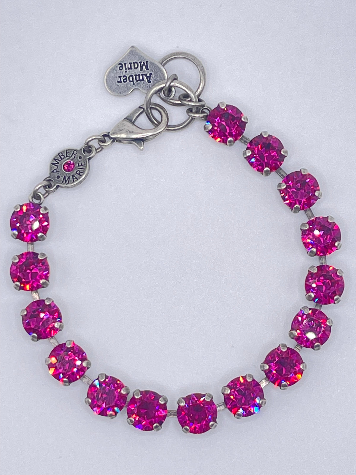 Classic Vienna bracelet featuring round, vibrant pink crystals set in silver-tone metal links.