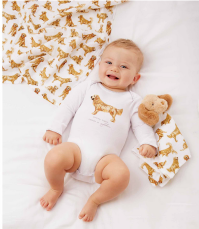 Baby wearing a long sleeve golden retriever bodysuit next to a matching printed bib.