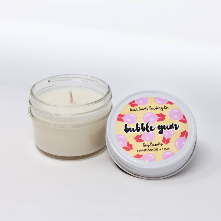 Pop Scents soy candle in a cylindrical glass jar with a white label.