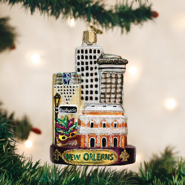 Hand-painted glass New Orleans ornament featuring Bourbon Street, a Mardi Gras mask, and city skyline.